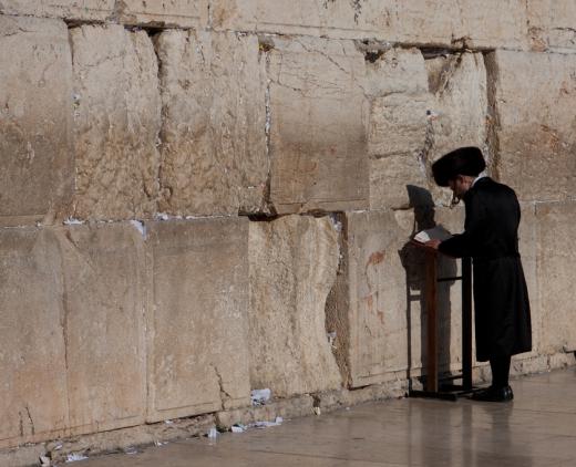 Man praying at the Kotel (Western Wall) in Jerusalem.