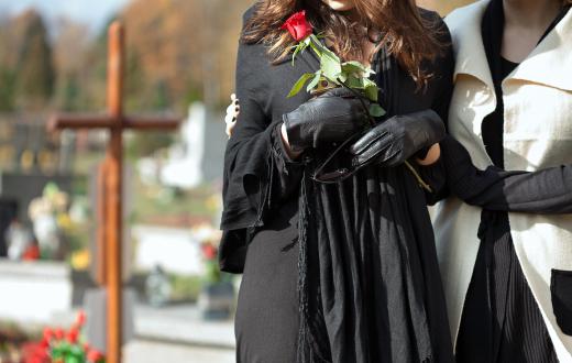 Mourners may bring flowers or other gifts with them to a cemetery.