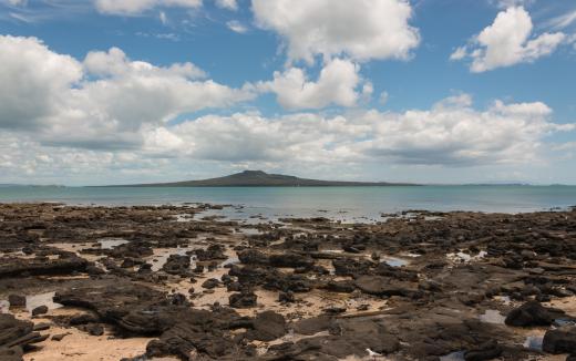 The Mariana Islands, which are volcanic islands that were formed by the collsion of tectonic plates, sit opposite the Mariana Trench, which is the deepest point on Earth.